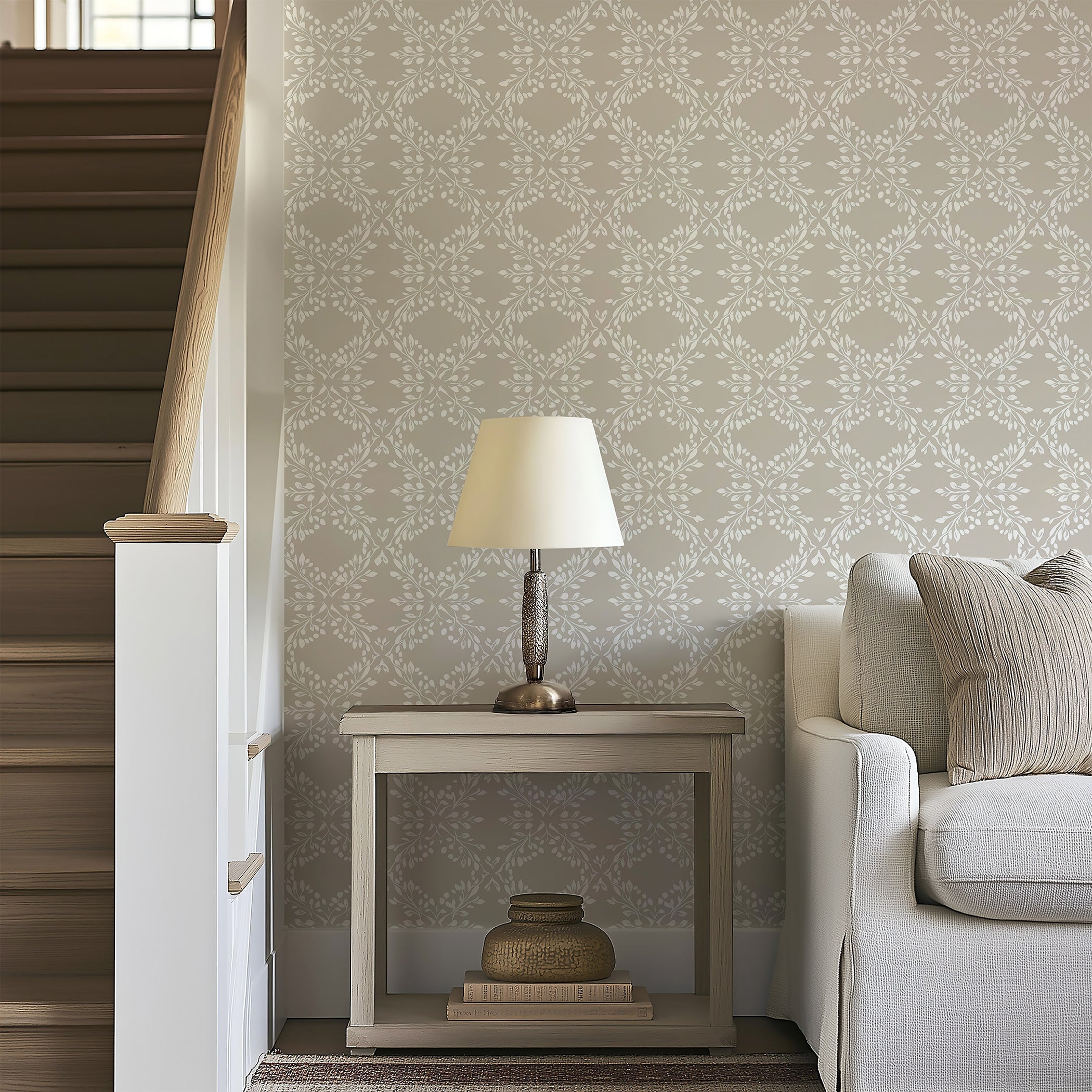 Alt Tag: Whimsical Trellis Melody wallpaper with laurel wreaths, branches, and neutral tones of white and gray, enhancing a serene living room.