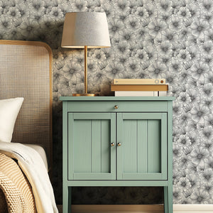 Monochromatic Inked Petals wallpaper with a modern design in a bedroom featuring a green nightstand and lamp.