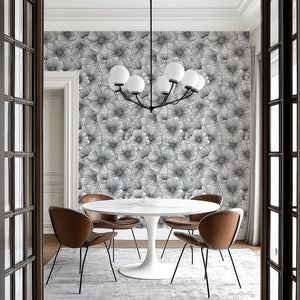 Inked Petals wallpaper featuring monochromatic floral design in a modern dining space with stylish furniture.