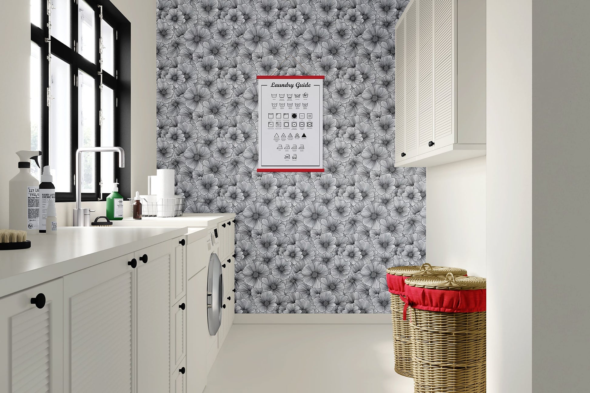 Inked Petals monochrome floral wallpaper in a modern laundry room with white cabinets and stylish storage baskets.