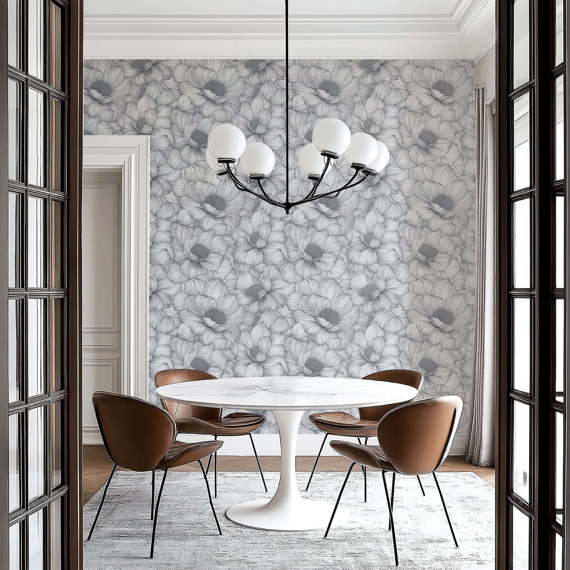 Monochrome floral wallpaper in a dining room with a modern chandelier and stylish furniture, highlighting botanical elegance.