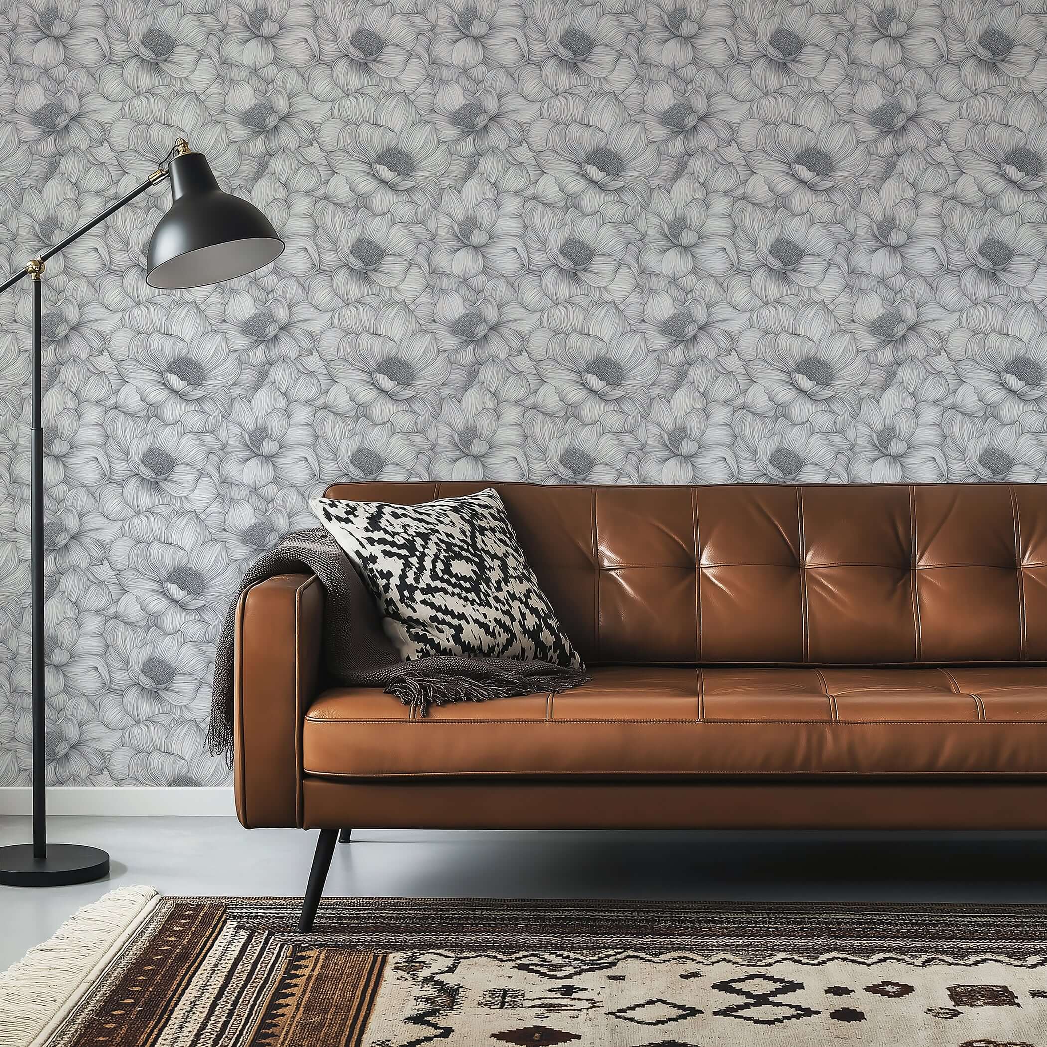 Graphite Garden Dance wallpaper with hand-inked floral pattern in monochrome tones, enhancing modern living room decor with organic texture.