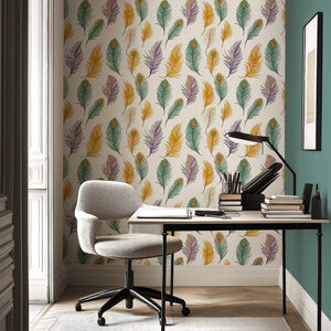 A stylish home office featuring 'Feather Fantasy' wallpaper with peacock feathers in mustard, green, violet, and taupe shades.