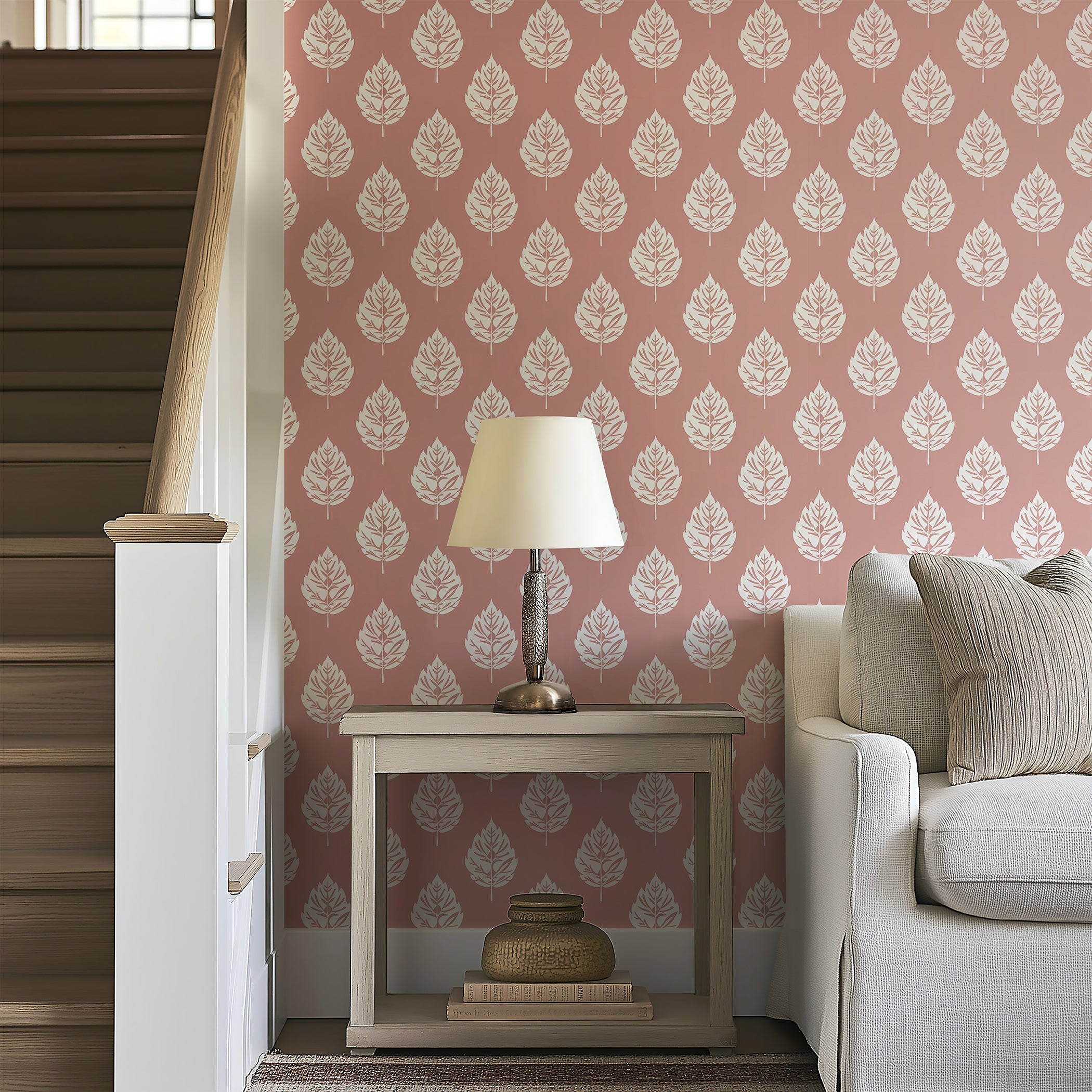 Blush Leaf wallpaper featuring white leaf patterns on a pink background enhances a cozy living space with charm and style.