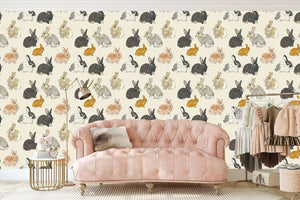 Whimsical wallpaper with hand-drawn bunnies in natural shades on a tan background, perfect for nurseries and children’s rooms.