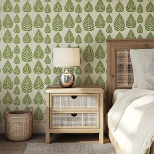 Fernwood Forest wallpaper featuring green ferns and leaves on creamy background in a serene bedroom setting.