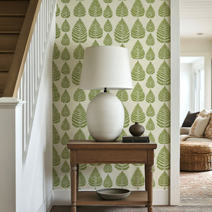 Fernwood Forest wallpaper featuring stylized green fern fronds on a cream background in a cozy home setting.