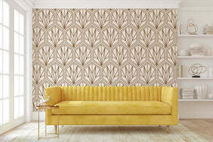 Art Deco geometric wallpaper with bronze hexagonal pattern on a cream wall, enhancing the living room's elegance with a yellow sofa.
