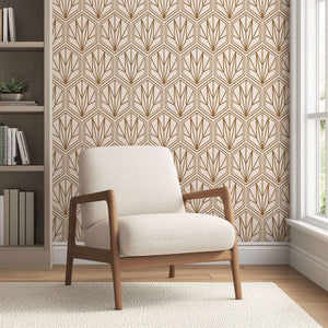 Art Deco geometric wallpaper with bronze hexagonal pattern and cream background in a cozy room with a modern chair.
