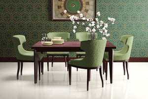 Dining room with Deco Botanic wallpaper featuring art deco geometric design, modern green chairs, and floral centerpiece.