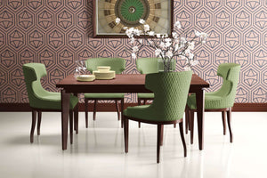 Art Deco dining room with green chairs, wooden table, and Prism Bloom geometric wallpaper in soft blush and navy hexagonal design.