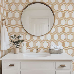 Art Deco geometric wallpaper with bronze hexagons on white in a modern bathroom setting.