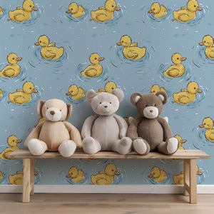 Playful Pond Party wallpaper with yellow ducks, perfect for children's nursery or playroom decor, shown with stuffed animals on a bench.