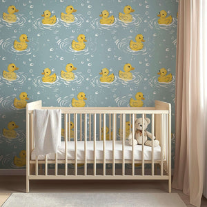 Charming duck-themed "Splish Splash" wallpaper in a nursery with a crib, perfect for adding playful charm to any child's room.