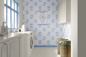 Sweetheart Blooms wallpaper with blue floral design enhances a modern laundry room, ideal for nurseries and playrooms."