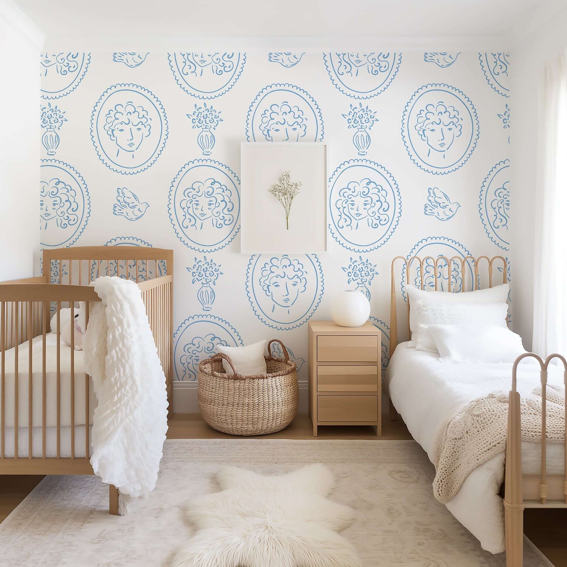 Room with 'Curly Locks & Friends' wallpaper, featuring blue portraits, florals, and birds on a white background. French, modern design.