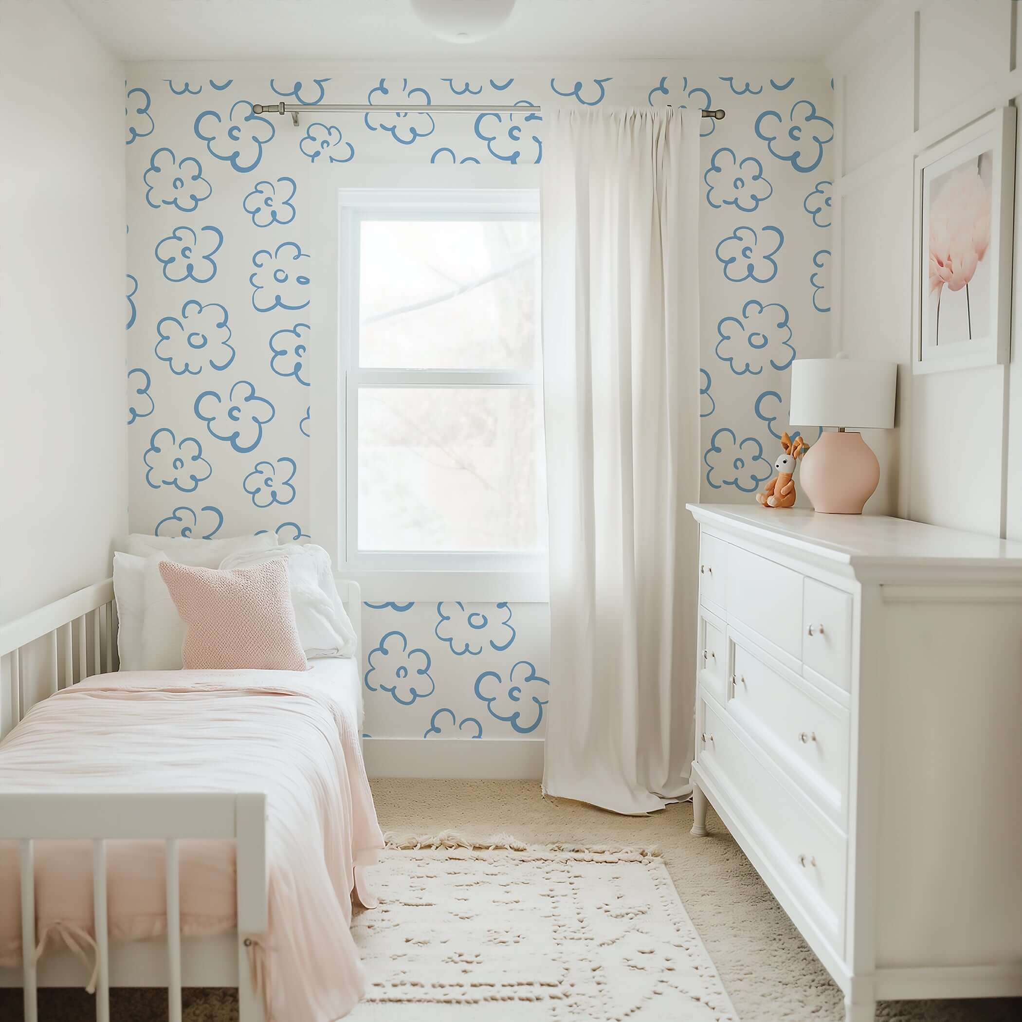 Modern blue and white floral wallpaper in a cozy bedroom, featuring abstract flower designs for a playful and minimalist look.
