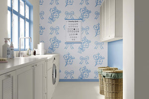 Laundry room with blue and white French wallpaper featuring hand-drawn flowers and ribbons, adding elegance and charm.