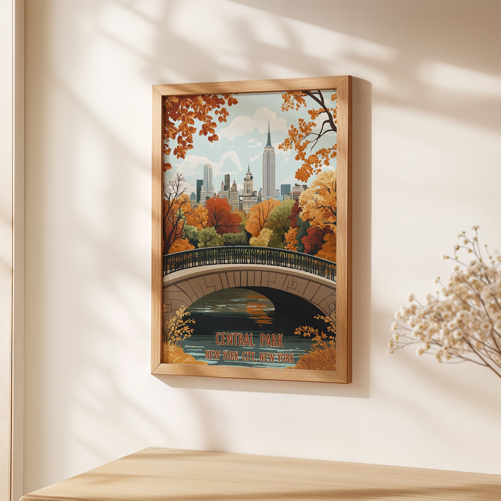 Autumn wall art print of Central Park featuring warm fall colors, a bridge, and the NYC skyline.