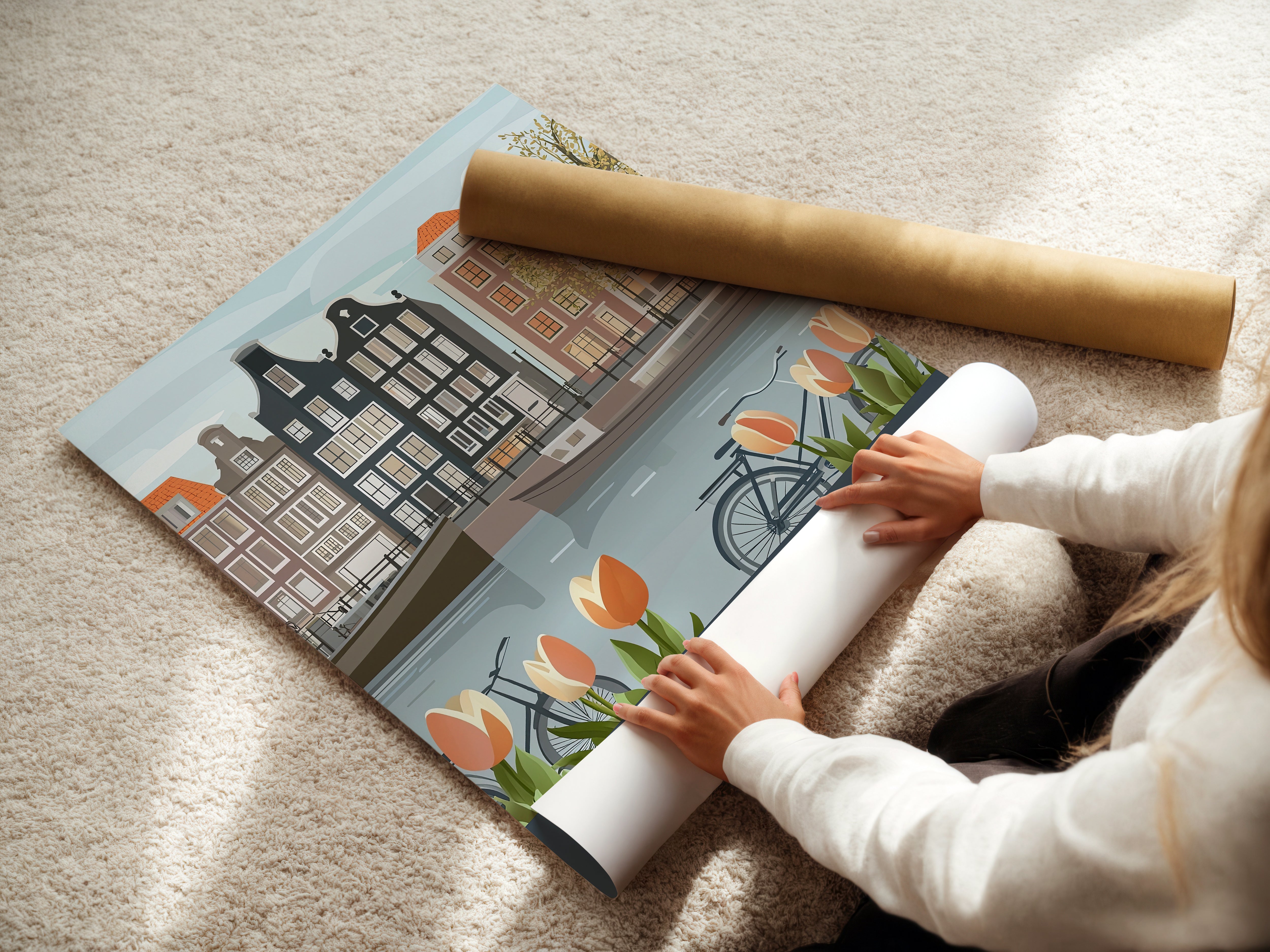 Person unrolling a Vintage Amsterdam art print featuring canals, tulips, bicycles, and Dutch architecture.