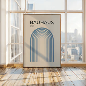 Bauhaus 1919 art print in a sunlit room, featuring a blue gradient arch design, representing modern design and simplicity.