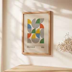Bauhaus art print featuring geometric shapes and vibrant colors in modern design, framed on a wall.