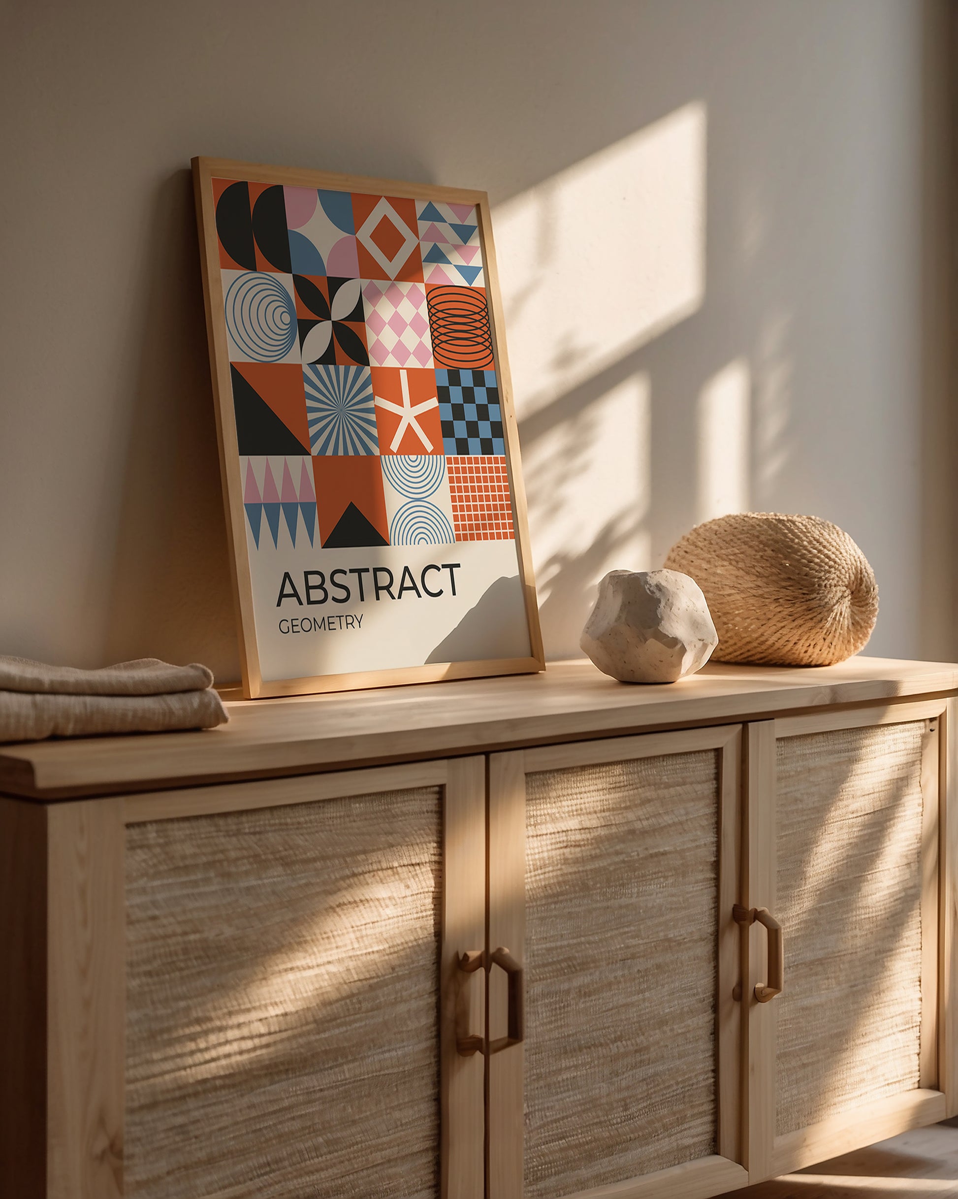Modern color block art print featuring geometric shapes on a wooden cabinet with natural light.
