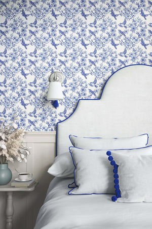 Elegant bedroom with Songbird Garden Toile wallpaper featuring blue-and-white songbirds, perfect for French toile vintage decor.
