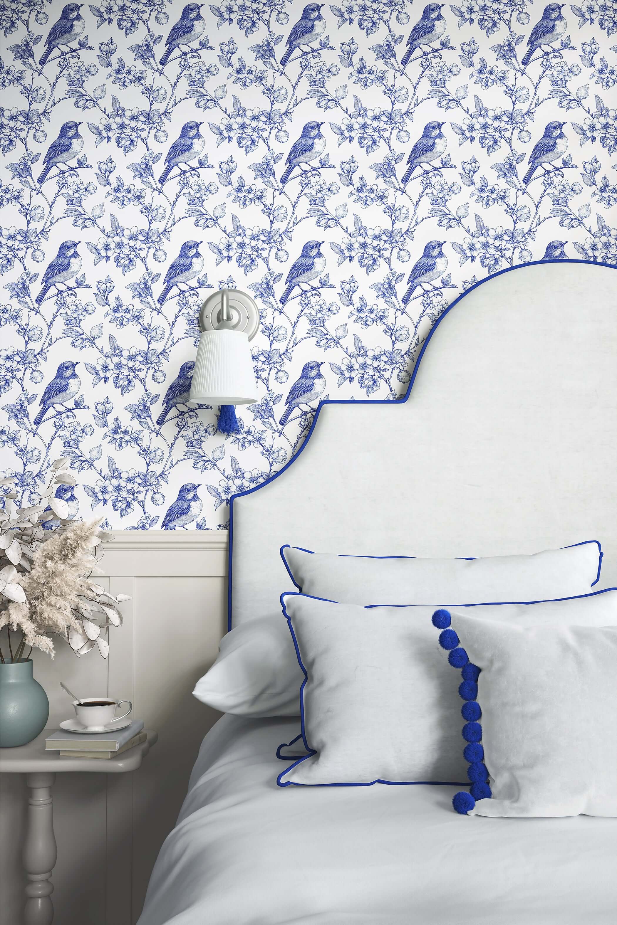 Blue songbird garden toile wallpaper in bedroom, featuring elegant vintage-style French toile design and classic blue birds on branches.