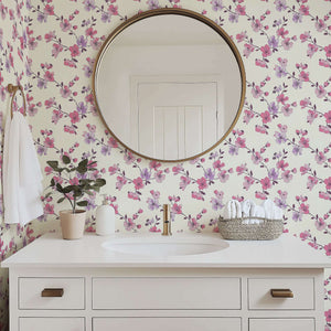Elegant bathroom with "Botanical Blush" wallpaper featuring pink and lilac floral design, enhancing modern decor with a romantic touch.