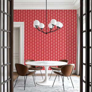 Dining room with modern monarchy motif wallpaper featuring pink royal silhouettes on a red background, inspired by London and England.