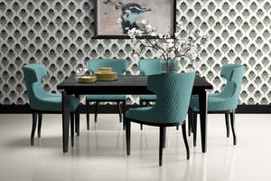 Dining room with teal chairs and black table set against sophisticated plume peacock feather wallpaper, art deco style.
