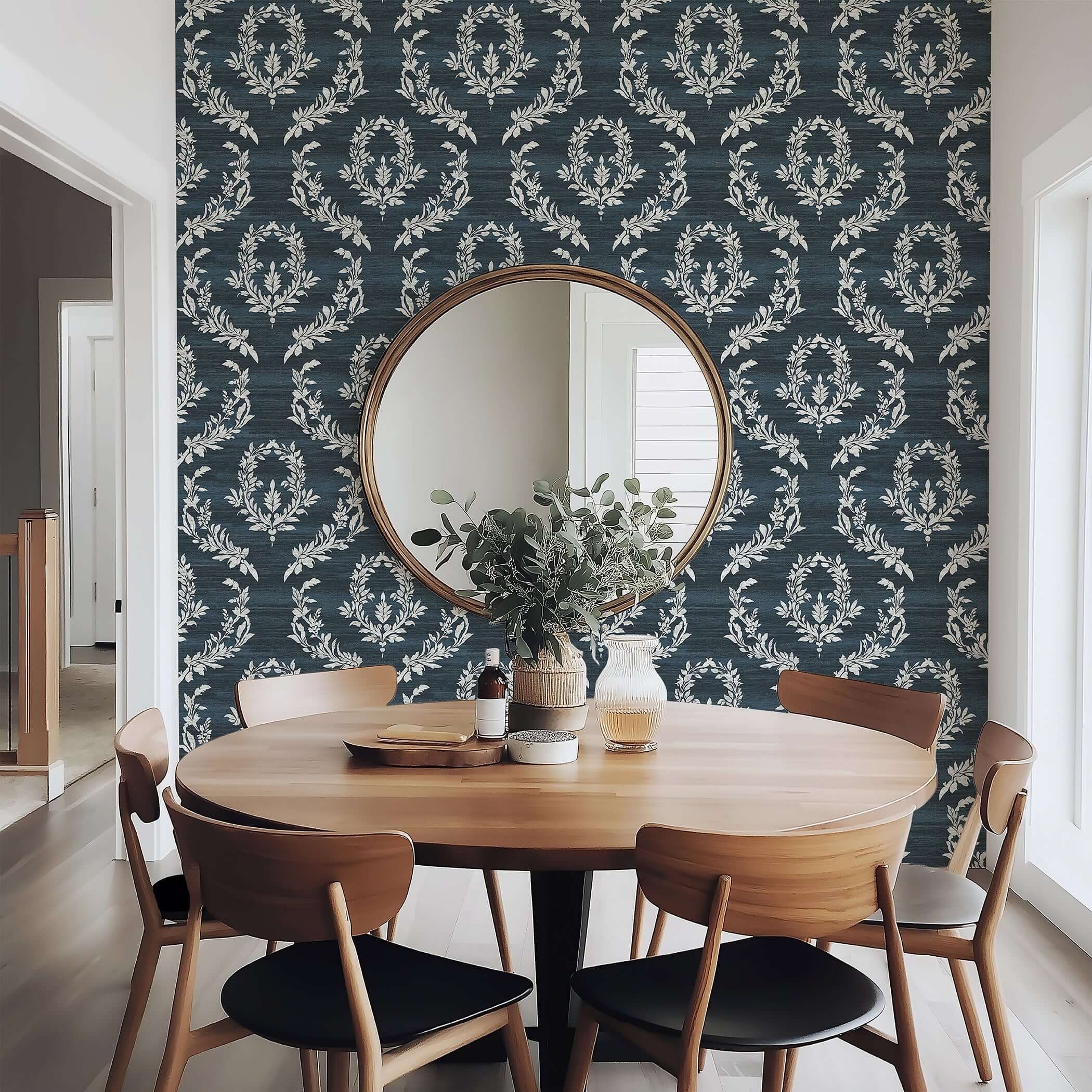 Dining room with Midnight Laurel wallpaper featuring white laurel wreaths on dark blue, accentuating traditional and contemporary designs.