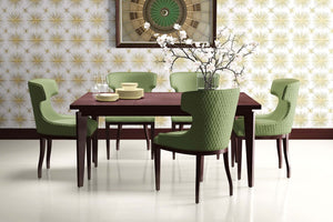 Dining room with green chairs, wooden table, and Vintage Gold Star mid-century modern wallpaper featuring a retro starburst pattern.