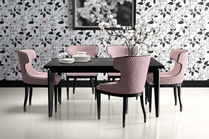 Elegant dining room with modern floral wallpaper featuring monochromatic blossoms and sleek black dining set with blush chairs.