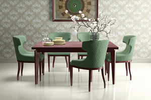 Elegant dining room with green chairs, wooden table, and Delicate Bloom Collection wallpaper featuring traditional floral motifs.