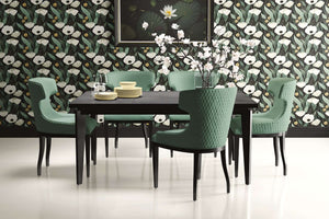 Modern dining room with Gilded Night Botanicals wallpaper featuring bold white flowers, sage leaves, and gold accents on a black background.