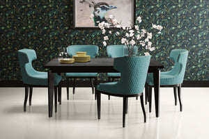 Dining room with teal chairs and table set against Celestial Peacock wallpaper featuring art deco peacock feathers.