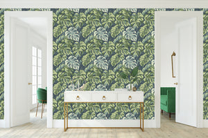 Tropical Canopy wallpaper featuring lush monstera leaves in green on a coastal background, perfect for home decor.