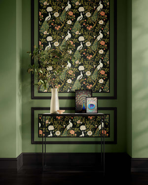 Art deco wallpaper with white peacocks and floral design in dark green background, featuring a stylish interior decor setup.