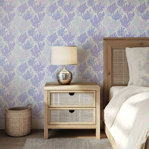 Bedroom with Coral Reflection Wallpaper featuring lavender and blue coral designs, enhancing a coastal ambiance.