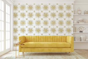 Living room with Vintage Gold Star wallpaper, featuring a Mid-Century Modern retro starburst design, yellow sofa, and white decor.