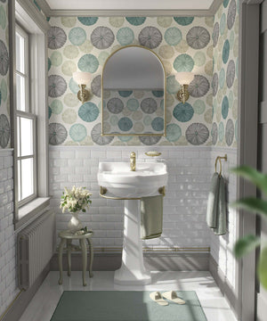 Bathroom with modern sea urchins wallpaper in teal and sage, featuring coastal design accents and a white pedestal sink for a beach ambiance.