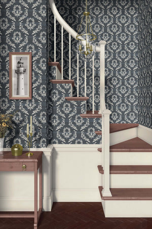 Elegant stairway with Midnight Laurel wallpaper featuring soft white laurel wreaths against a dark blue background; traditional florals.