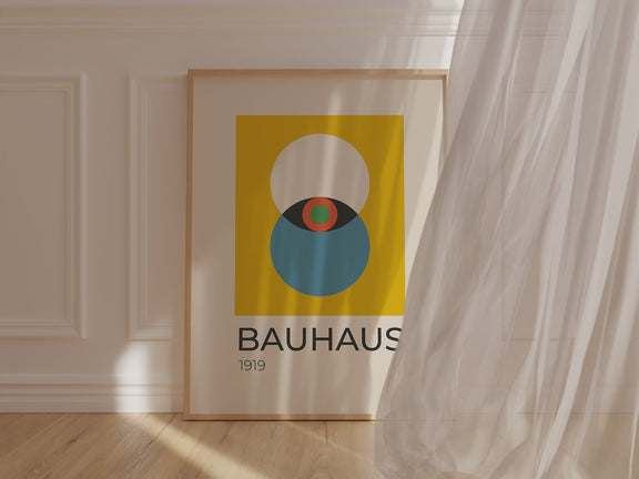 Bauhaus wall art print featuring bold colors and geometric shapes, framed in a warm golden border.