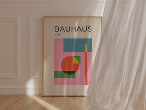 Bauhaus art print featuring abstract shapes and vibrant colors on a pink backdrop, showcasing modern art design.