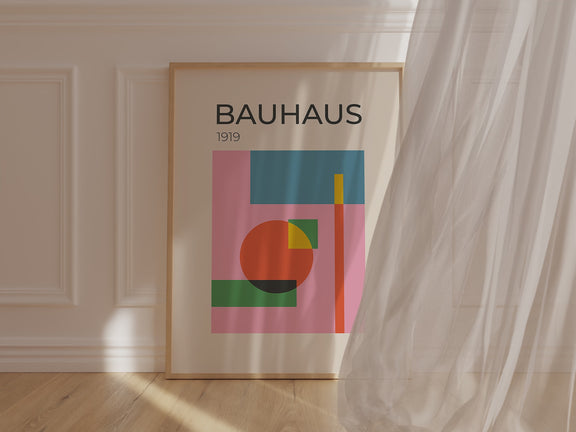 Bauhaus art print featuring abstract shapes and vibrant colors on a pink backdrop, showcasing modern art design.