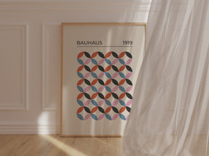 Bauhaus-inspired wall art print featuring geometric shapes and vibrant colors in a modern interior setting.